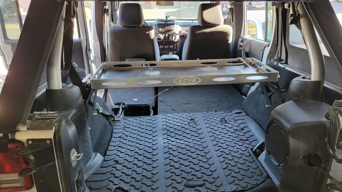 Empty Jeep Wrangler cargo bay with a GR storage rack mounted, set up to carry our full overland gear list.