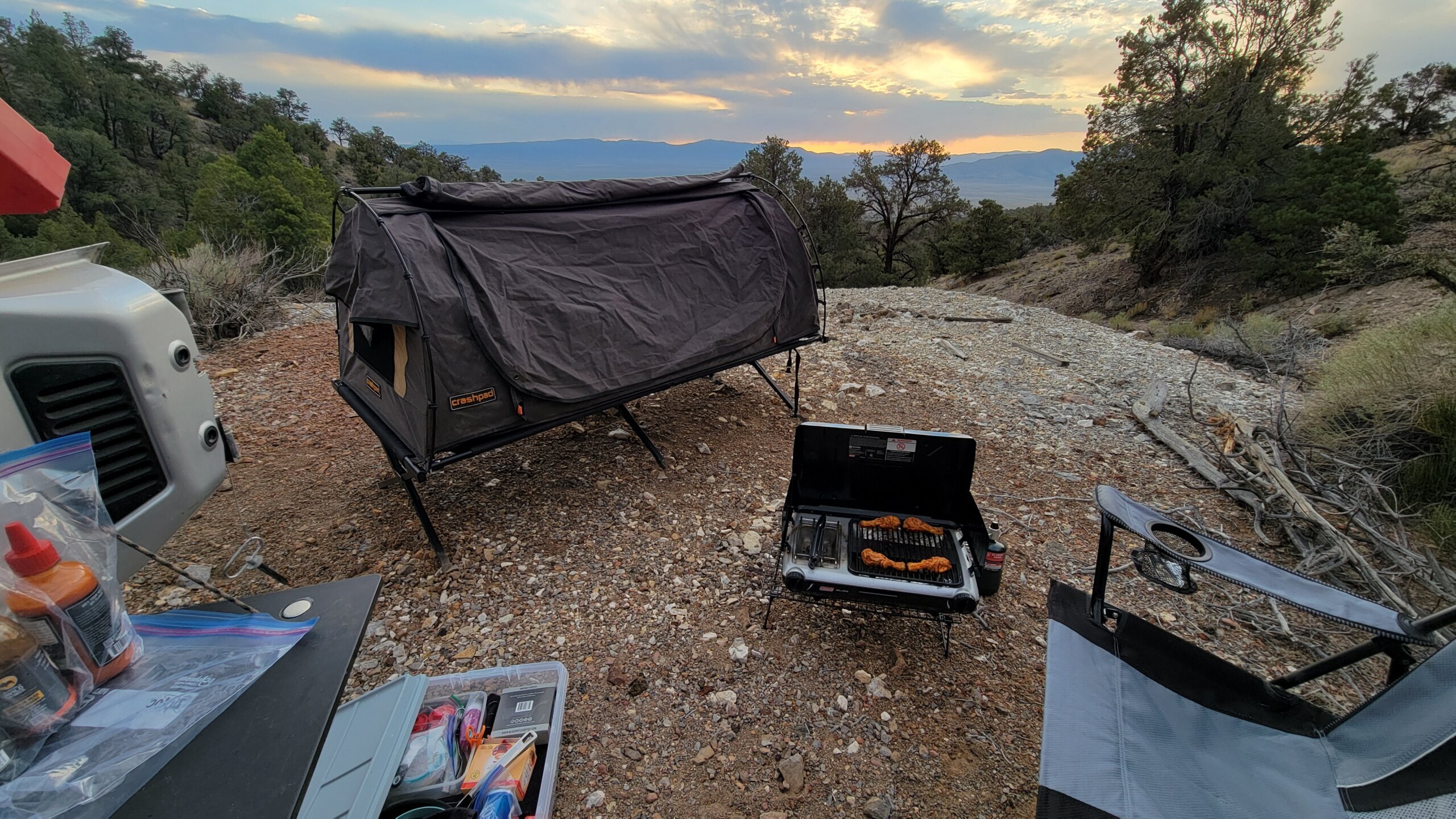 Camp cooking setup at golden hour in desert landscape