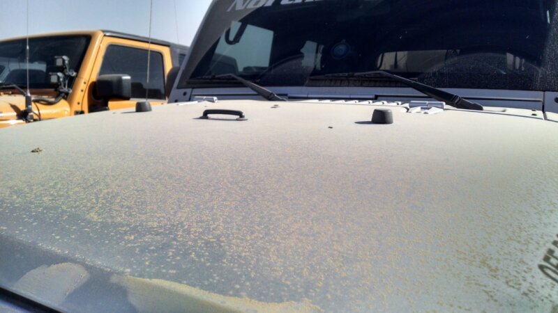 Dust-covered Jeep hood at King of the Hammers, caked in a thick layer of desert dust